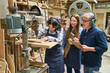 © Robert Kneschke - Teamwork in a lumberyard with apprentices and skilled mentor