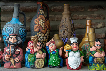 A collection of ceramic figurines, including a woman with a basket and a man with a beard