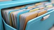 © Planetz - Colorful file folders organized in a blue filing cabinet showcasing documentation and data management in an office environment