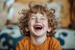 © ADDICTIVE STOCK CORE - Excited young boy laughing in a cheerful, casual setting