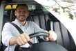 © New Africa - Happy man behind steering wheel of modern car, view through windshield