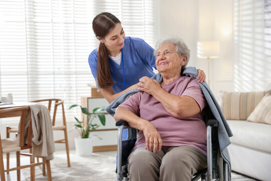Wall Mural -  - caregiver covering senior woman with blanket indoors. home health care service