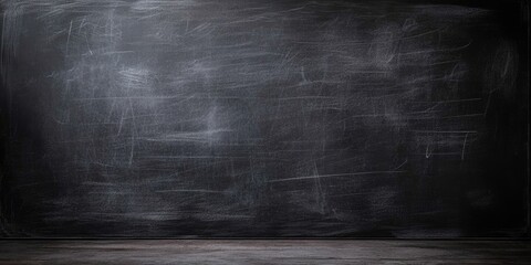 Empty textured black chalkboard background with subtle scratches and a wooden floor at the bottom, ideal for educational or creative uses.