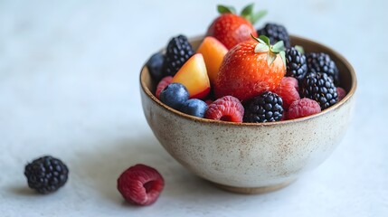 Colorful fruit bowl, vibrant assortment of berries and citrus in wooden bowl on light background, fresh and healthy snack theme.