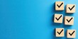 © Ahmad - Checklist with black check marks on wooden blocks arranged in two rows against a solid blue background emphasizing approval and evaluation themes