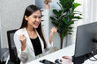 © Summit Art Creations - Successful in working young Asian businesswoman getting marketing online analysis service project with raising fist up, analyzing on social media website for planning channel sales target. Stratagem.