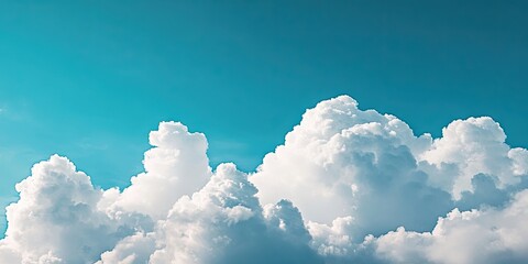 Sticker - Fluffy white clouds scattered against a bright turquoise sky providing ample blank space for text and design elements in the upper half.