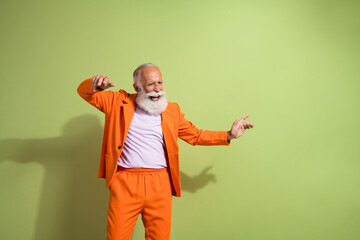 Canvas Print - Portrait of funky eccentric grandfather dance empty space wear orange suit isolated on green color background