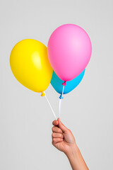 Wall Mural - Close-up hand holding balloon isolated white background