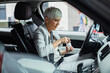 © Davor - Senior businesswoman taking vitamins in car