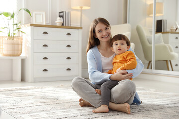 Canvas Print - Happy mother hugging her little son at home. Space for text