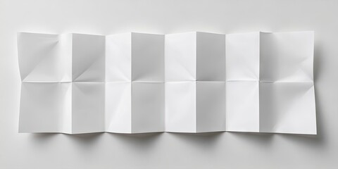 Sticker - Blank white sheet of paper folded into eight sections lying flat on a light surface with subtle shadows highlighting creases and folds