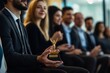 © Patel Studio - Young business team receiving award prize at best business project competition event. Business and entrepreneurship award ceremony theme. Focus on unrecognizable people in audience., Generative AI