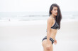 © NT_studio - Beautiful young asian woman standing with happiness for relax on beach in tropical, happy woman in bikini with expression relaxation in holiday with seductive, recreation and leisure in summer.