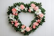 © Arfa_Media - Heart-shaped wreath hanging on white wooden wall forming a perfect heart framing empty space