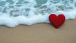 © Arfa_Media - Red heart standing on the beach getting wet by the ocean waves