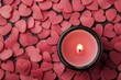 © Arfa_Media - Pink scented candle burning surrounded by heart-shaped wax melts