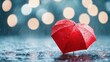 © Arfa_Media - Red umbrella heart shaped standing on wet asphalt during rain with bokeh lights in background