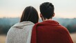 © Arfa_Media - Couple enjoying mountain landscape at sunset covered by blanket