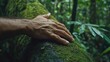 © Bijac - a hand rests on a moss-covered tree trunk, connecting with nature's beauty and serenity, symbolizing growth and harmony within a lush forest