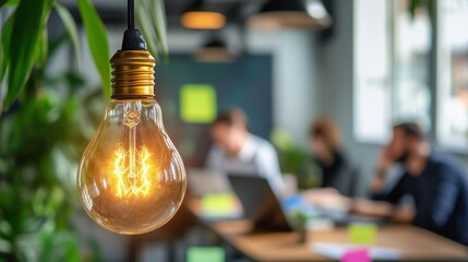 Aufkleber - Glowing light bulb with intricate filaments illuminating a modern workspace filled with professionals focused on tasks