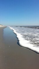 Wall Mural - Ocean Wave Foam on Sandy Beach Photo