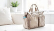 © Nikole24 - Functional stylish diaper bag on table, parenting essentials