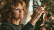 © Stefan - Mature Woman Decorating Christmas Tree in Evening Light