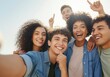© Sandor - Group of cheerful young students taking a selfie outdoors, pointing at the sky with their fingers