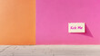 © Bonsales - Handwritten kick me note affixed to pastel wall, capturing minimalist photographic style with clean visual simplicity