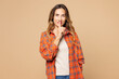 © ViDi Studio - Young secret woman wear orange shirt casual clothes say hush be quiet with finger on lips shhh gesture look camera isolated on plain pastel light beige background studio portrait. Lifestyle concept.