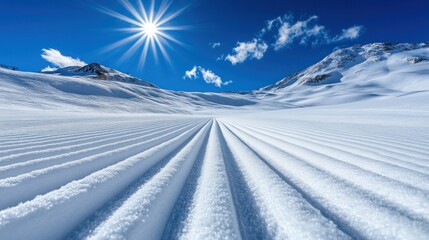 Wall Mural - Pristine snow groomer tracks across a vast snowy mountain landscape under a bright sun.