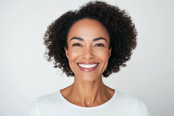 Wall Mural - Woman with curly hair is smiling and looking at the camera