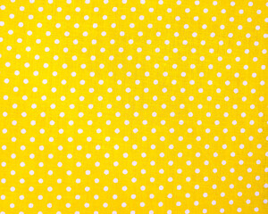 Full frame close-up of yellow fabric with white color polka dots