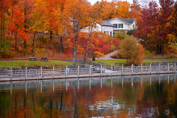 old house in autumn on the lake