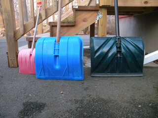 3 snow shovels beneath the back stairs in winter