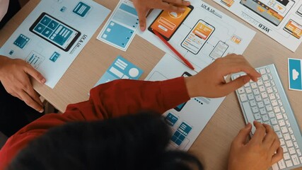 Wall Mural - top view panorama video of startup company employee planning on user interface prototype for mobile 