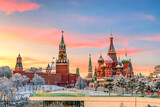 View of Kremlin and St. Basil Cathedral at the Red Square during sunset in winter. Famous landmarks in Moscow, Russia