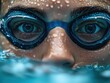 © Erich - Close-up of a swimmer's face with goggles, emerging from water