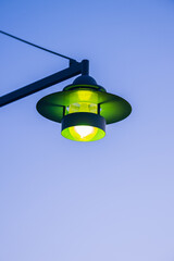 Wall Mural - Green light of a street lamp.