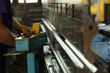 Poster - Crafting metal precision in a bustling workshop during daylight hours