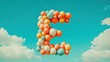 © Aquarius - Colorful balloon letter E against a blue sky.