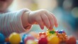 Child's hand reaching for colorful toy with softly blurred background