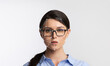 © Prostock-studio - A woman with glasses poses against a light background while facial recognition technology analyzes her features. The focus is on the facial mapping system highlighting key points.