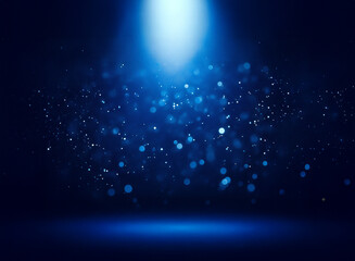 Wall Mural - a single, bright blue spotlight illuminates a dark background, with shimmering particles floating in