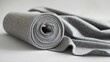 © Sampao - A roll of synthetic fiber fabric unrolled for cutting and tailoring.