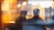 © CLOVER BACKGROUND - Blurred Office View of People Working Behind Glass Window