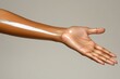 © Chatchaa - A sleek, bronzed arm extends with a glossy sheen, showcasing healthy skin against a neutral background.