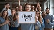 © patpongstock - business growing concept. Group of people expressing gratitude with a 'Thank You' sign.