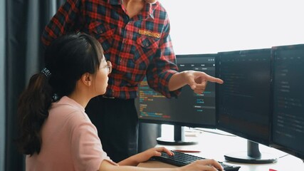 Slow motion back end or software developer manager supervising his team on new application program development on debugging and solving complex code algorithms on monitor. Burgeoning